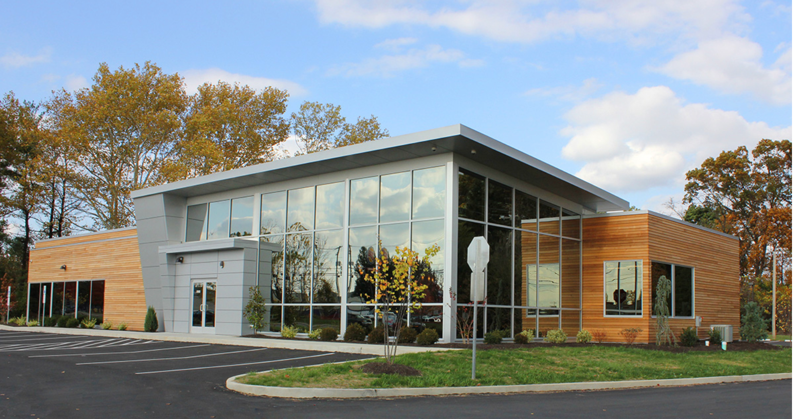 Modern orthodontic office building with angled roofline, glass facade, and wood siding — Sparks Orthodontics Bethlehem PA